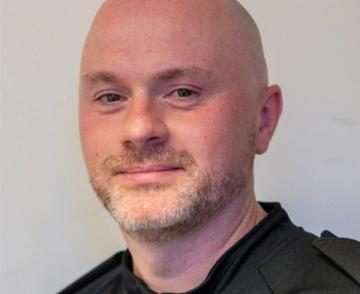 A headshot of the author, Chris Mckee